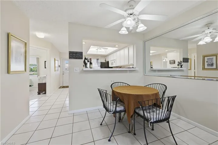 Dining space featuring light tile patterned floors, a ceiling fan, and a textured ceiling
