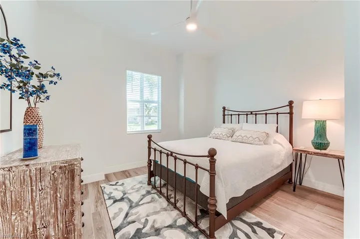 Bedroom with light hardwood / wood-style flooring and ceiling fan