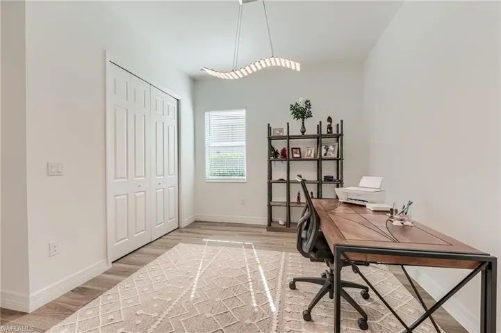 Home office with light wood-type flooring