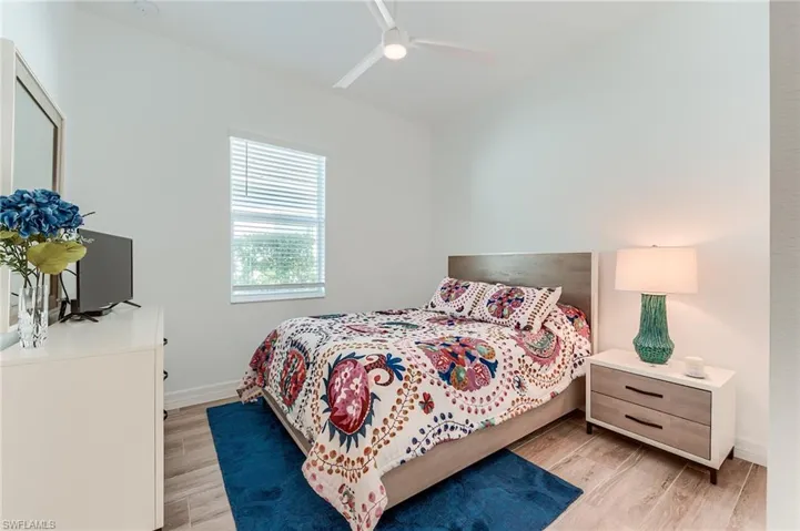 Bedroom with ceiling fan and light hardwood / wood-style flooring
