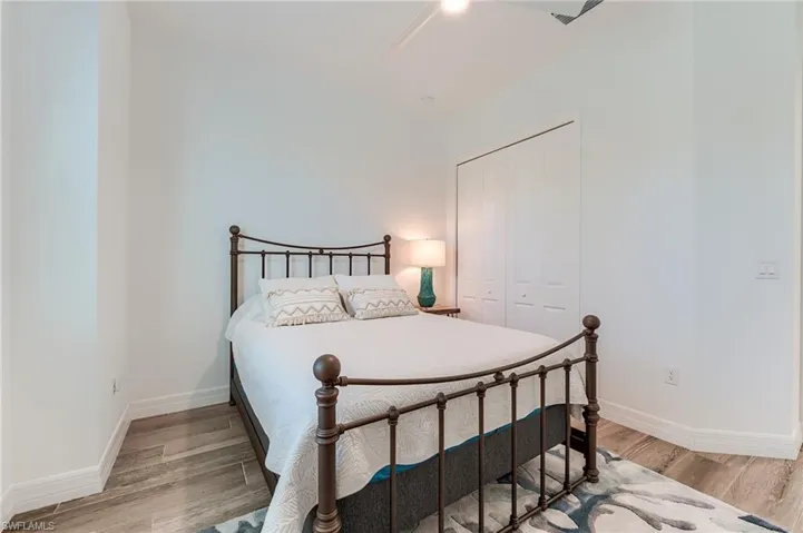 Bedroom featuring ceiling fan, a closet, and hardwood / wood-style floors