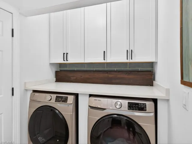 Laundry room featuring cabinet space and washing machine and dryer