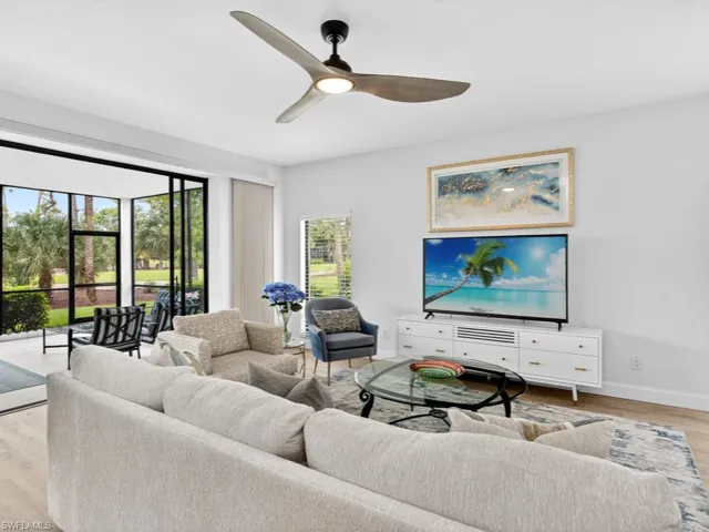 Living area with light wood-style flooring and a ceiling fan