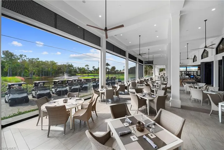 Dining space featuring ceiling fan, recessed lighting, and a high ceiling