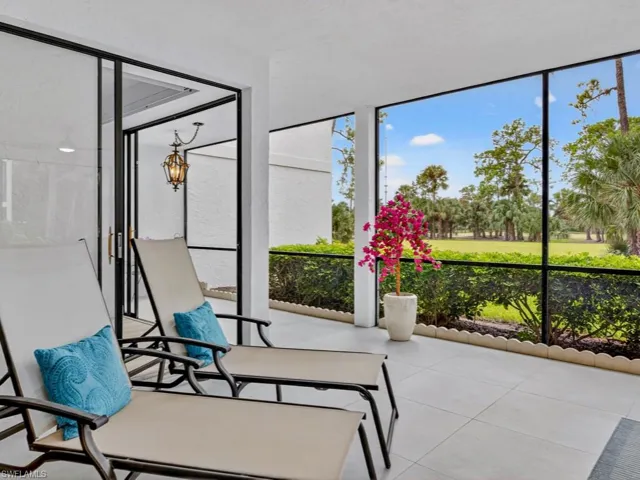 Sunroom / solarium featuring expansive windows and tile patterned flooring