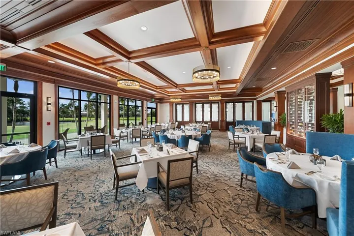 Dining space featuring beam ceiling, coffered ceiling, and dark carpet