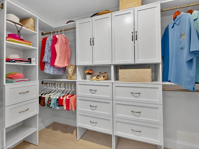 Walk in closet featuring light wood finished floors