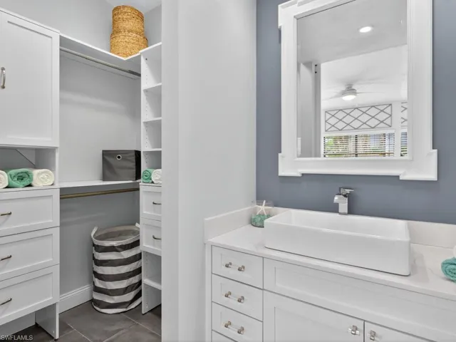 Bathroom featuring vanity and dark tile patterned floors