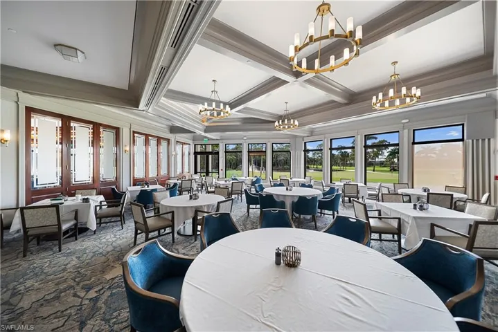 Dining area with coffered ceiling, beamed ceiling, carpet flooring, and ornamental molding