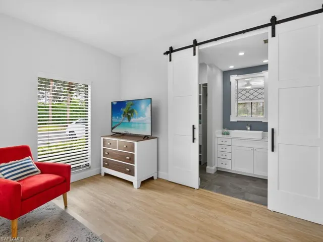 Sitting room with light wood finished floors and a barn door