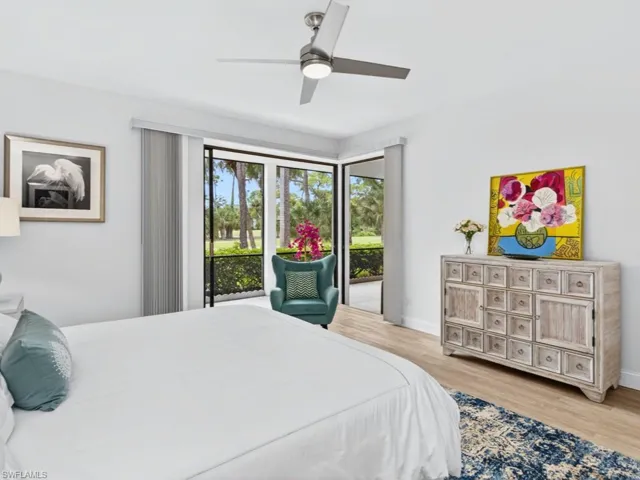 Bedroom featuring access to outside, light wood finished floors, and ceiling fan