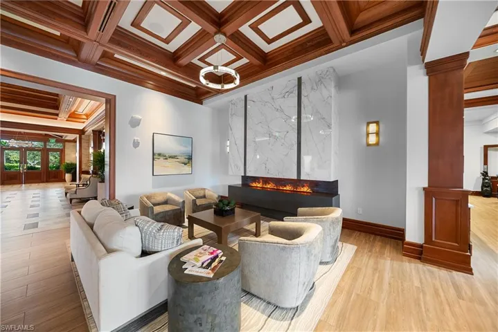 Common area with coffered ceiling, beam ceiling, and crown molding