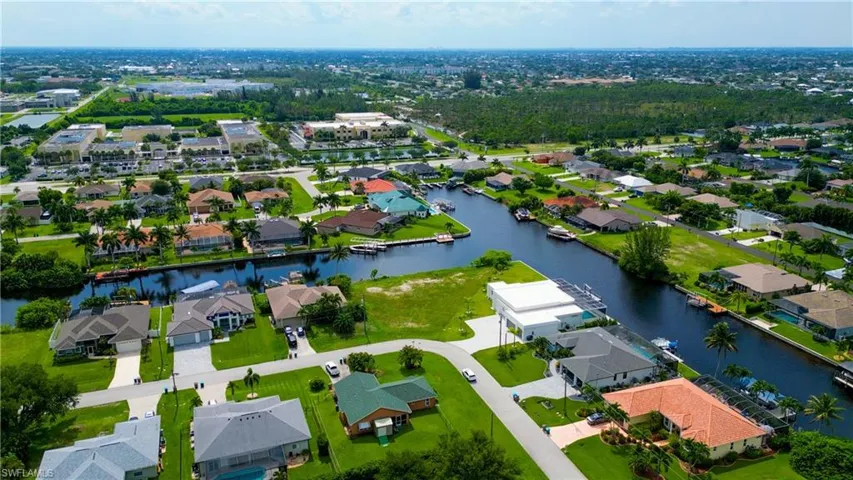 Aerial perspective highlighting canal-front properties, residential streets, and extensive green spaces