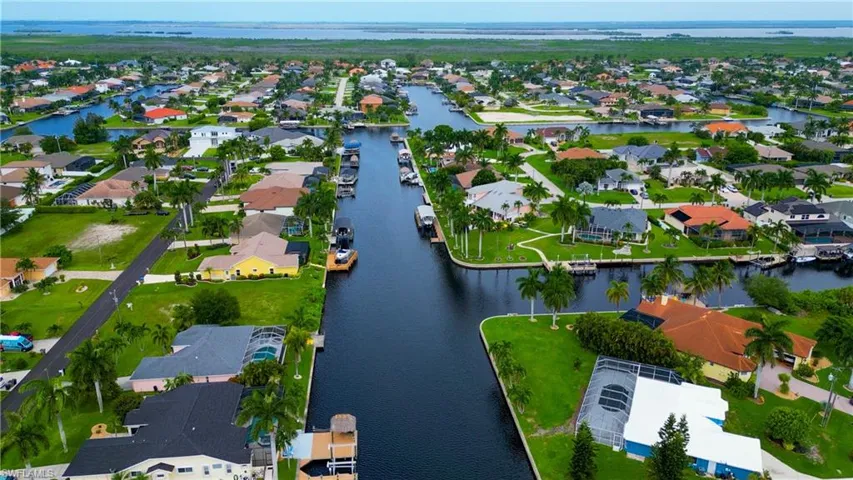 Aerial view of a residential community featuring extensive canal access