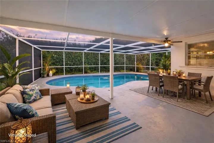 Outdoor pool featuring outdoor lounge area, a sunroom, a patio, and a lanai