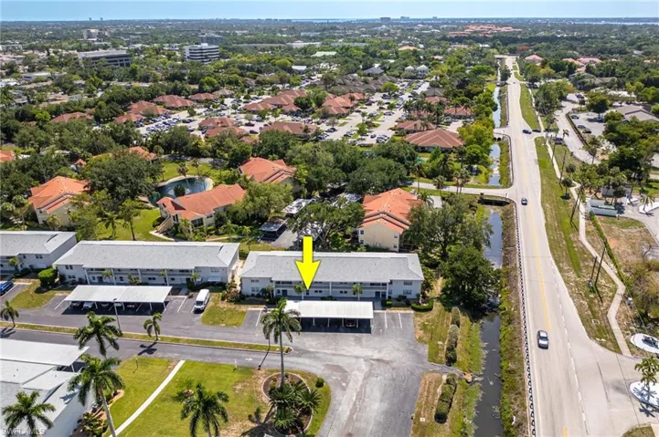 Aerial view of property and surrounding area featuring nearby suburban area