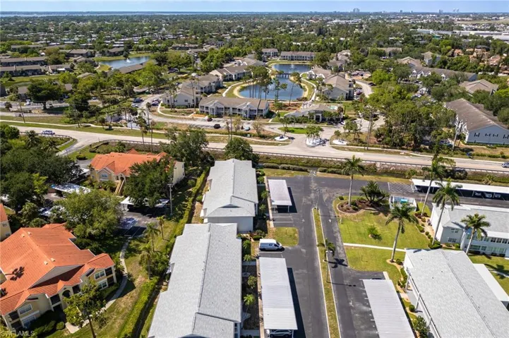 Aerial view of residential area featuring a nearby body of water