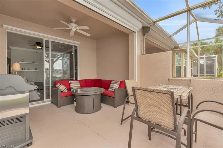 View of patio with ceiling fan, glass enclosure, and outdoor lounge area