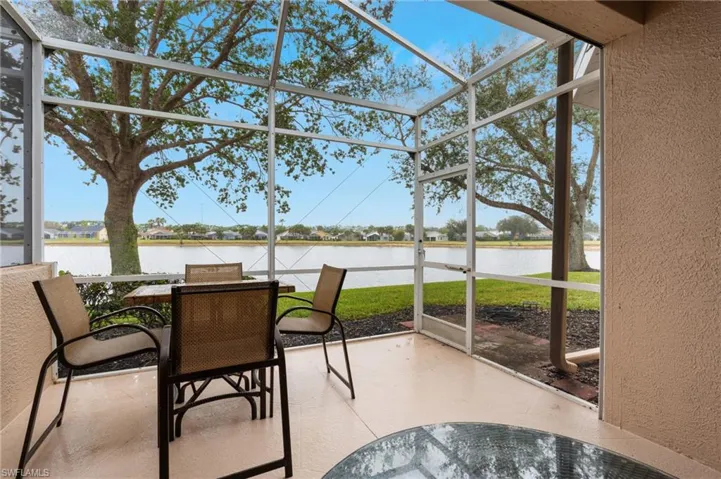 Sunroom featuring a water view and a healthy amount of sunlight