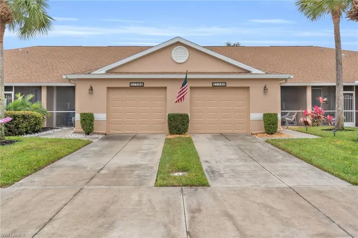 Single story home with a front yard, a garage, and a sunroom