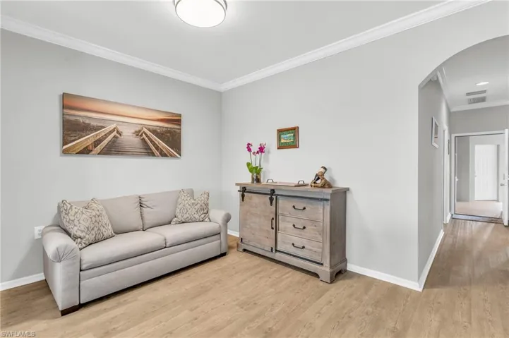 Living room featuring light hardwood / wood-style floors and ornamental molding