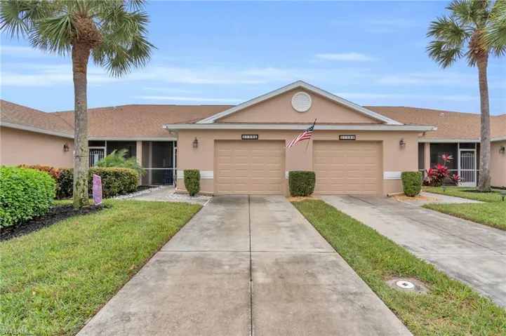 Single story home featuring a garage and a front lawn