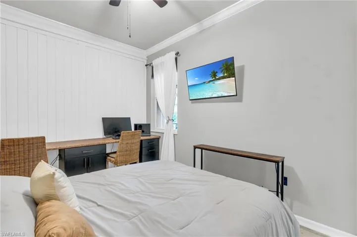Bedroom featuring ceiling fan and ornamental molding