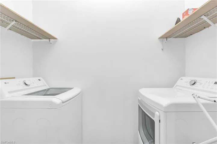 Washroom with washer and clothes dryer