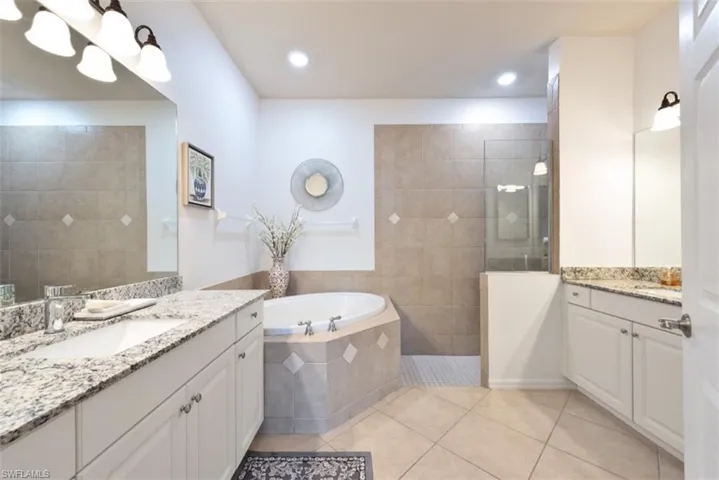Bathroom with vanity, plus walk in shower, and tile patterned flooring