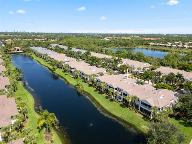 Birds eye view of property with a water view