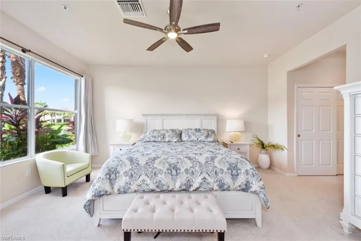 Carpeted bedroom with ceiling fan