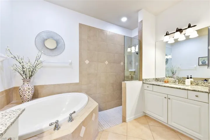 Bathroom with vanity, plus walk in shower, and tile patterned floors