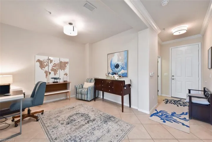 Office area with light tile patterned floors and ornamental molding