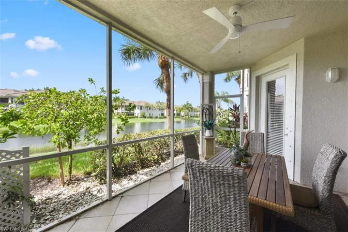 Sunroom with a water view and ceiling fan