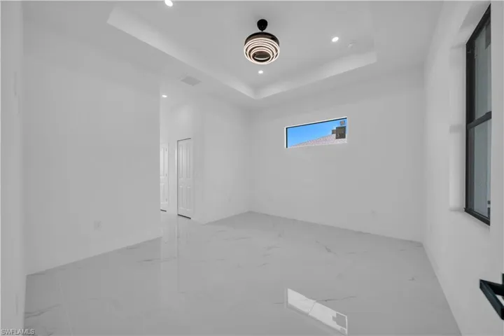 Empty room with recessed lighting and light marble finish floors