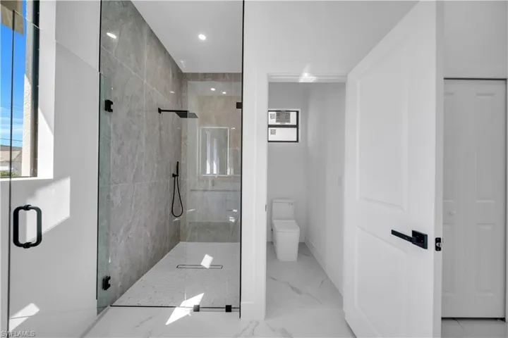 Bathroom featuring a stall shower and recessed lighting