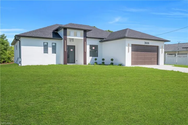 Prairie-style home featuring stucco siding, an attached garage, driveway, and roof with shingles
