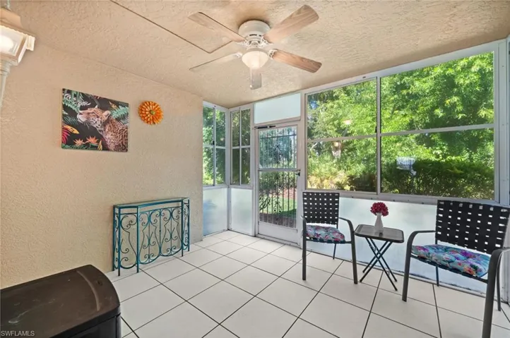 Sunroom with ceiling fan and completely tiled flooring