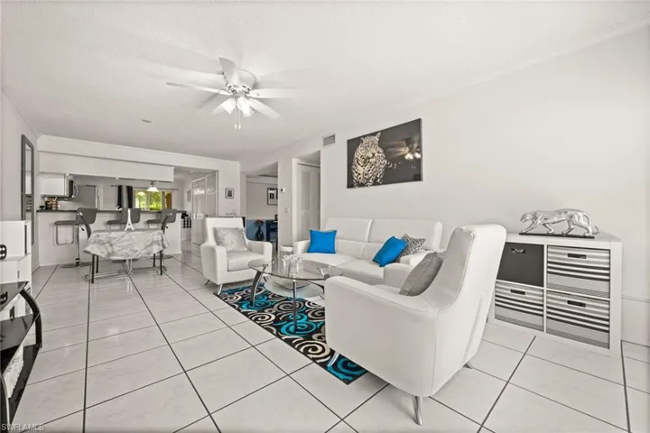 Living area showing dinette and breakfast bar, Featuring light tile patterned floors.