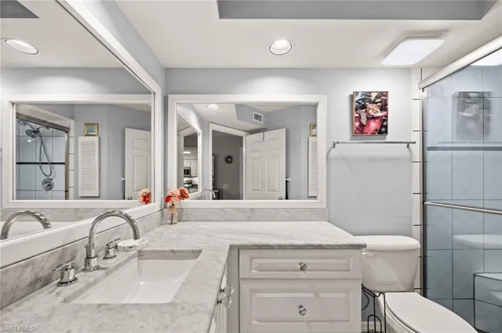 Full bathroom with a stall shower, vanity, and recessed lighting