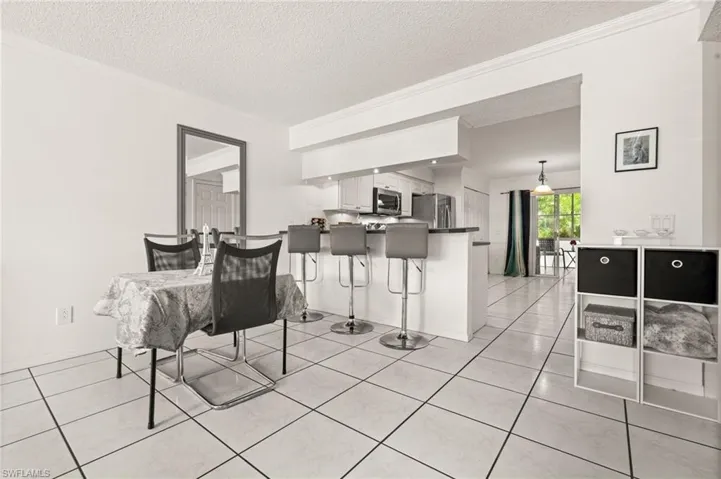 Dining area featuring the breakfast bar leading into the kitchen.