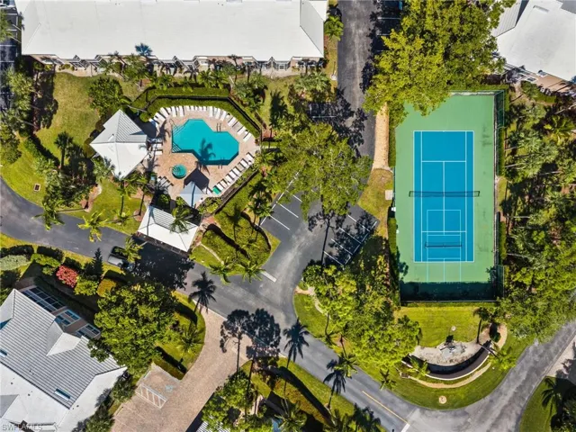 Drone / aerial view of the community pool and tennis courts.