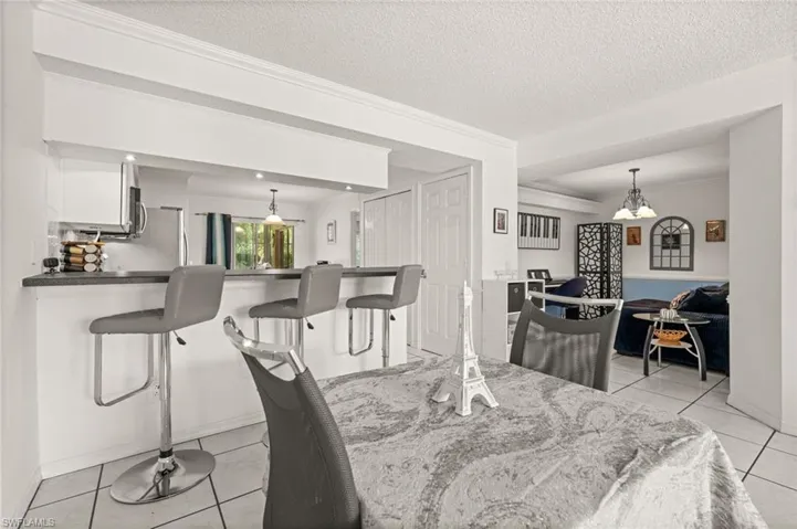 Dining area featuring the breakfast bar and den/office area.