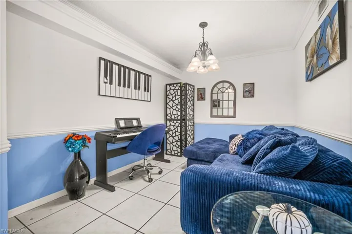 Den/Office space with ornamental molding, and tile flooring