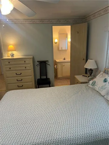 Bedroom featuring a sink and connected bathroom