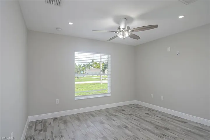 Empty room featuring light hardwood / wood-style flooring and ceiling fan