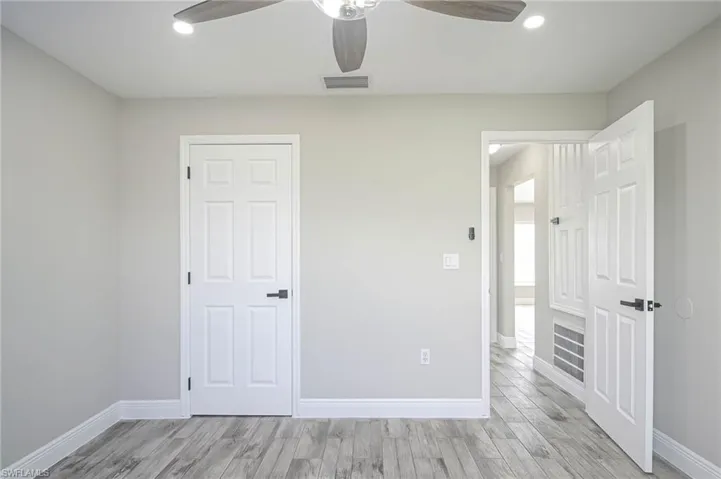 Unfurnished bedroom with light hardwood / wood-style flooring and ceiling fan
