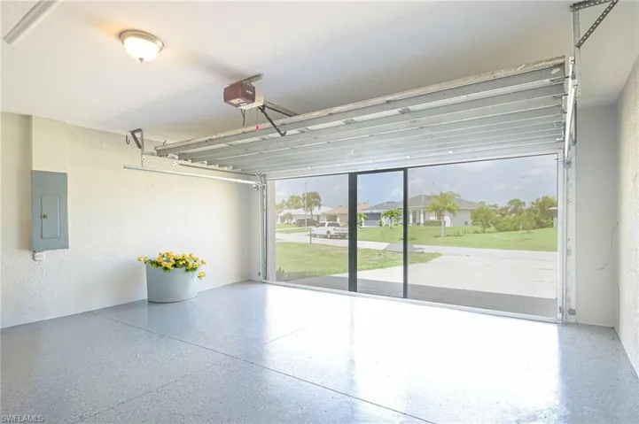 Garage with electric panel and a garage door opener