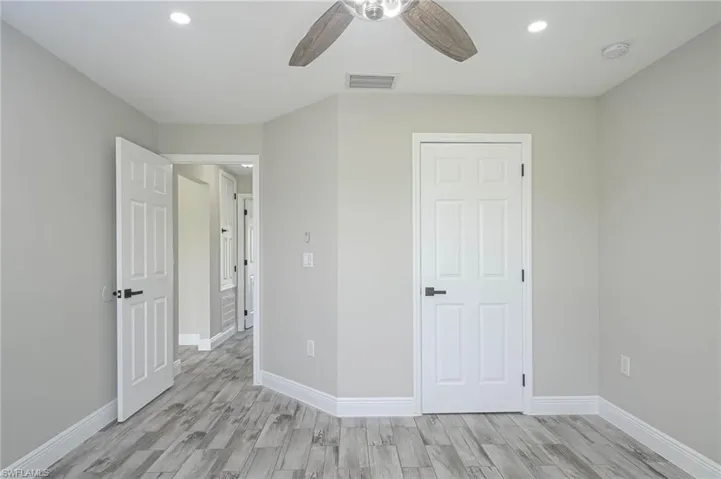Unfurnished bedroom featuring light hardwood / wood-style flooring and ceiling fan
