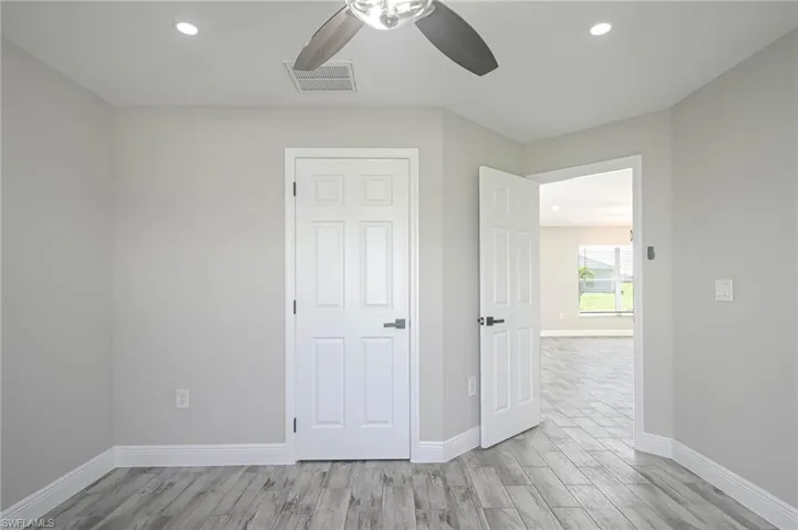 Unfurnished bedroom featuring light wood-type flooring and ceiling fan